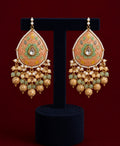 Orange meenakari earrings and tikka set with green detailing